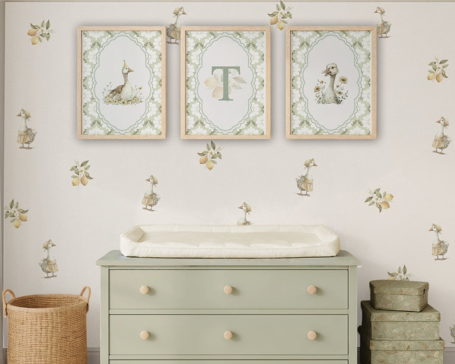 Nursery room with a green dresser, framed artwork, and decorative elements.