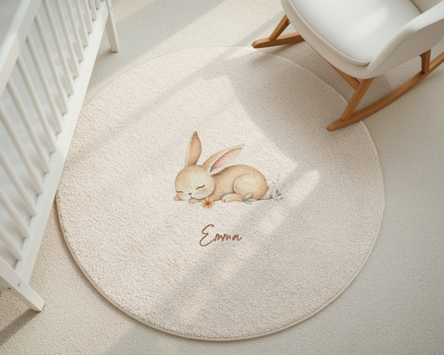 Round beige rug with a bunny design and 'Emma' text in a nursery setting.