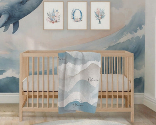 Nursery room with whale mural, crib, and decorative elements.