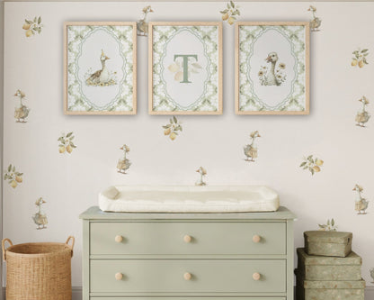 Nursery room with a green dresser, framed artwork, and decorative elements.