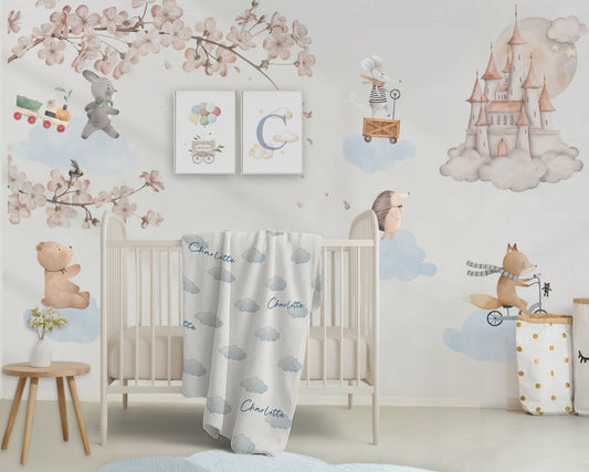 Children's nursery with crib, decorative wall art, and cloud-themed bedding.
