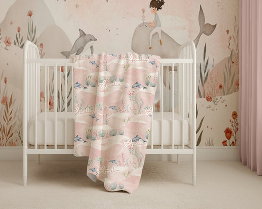 Crib with a floral blanket in a room with decorative wall art