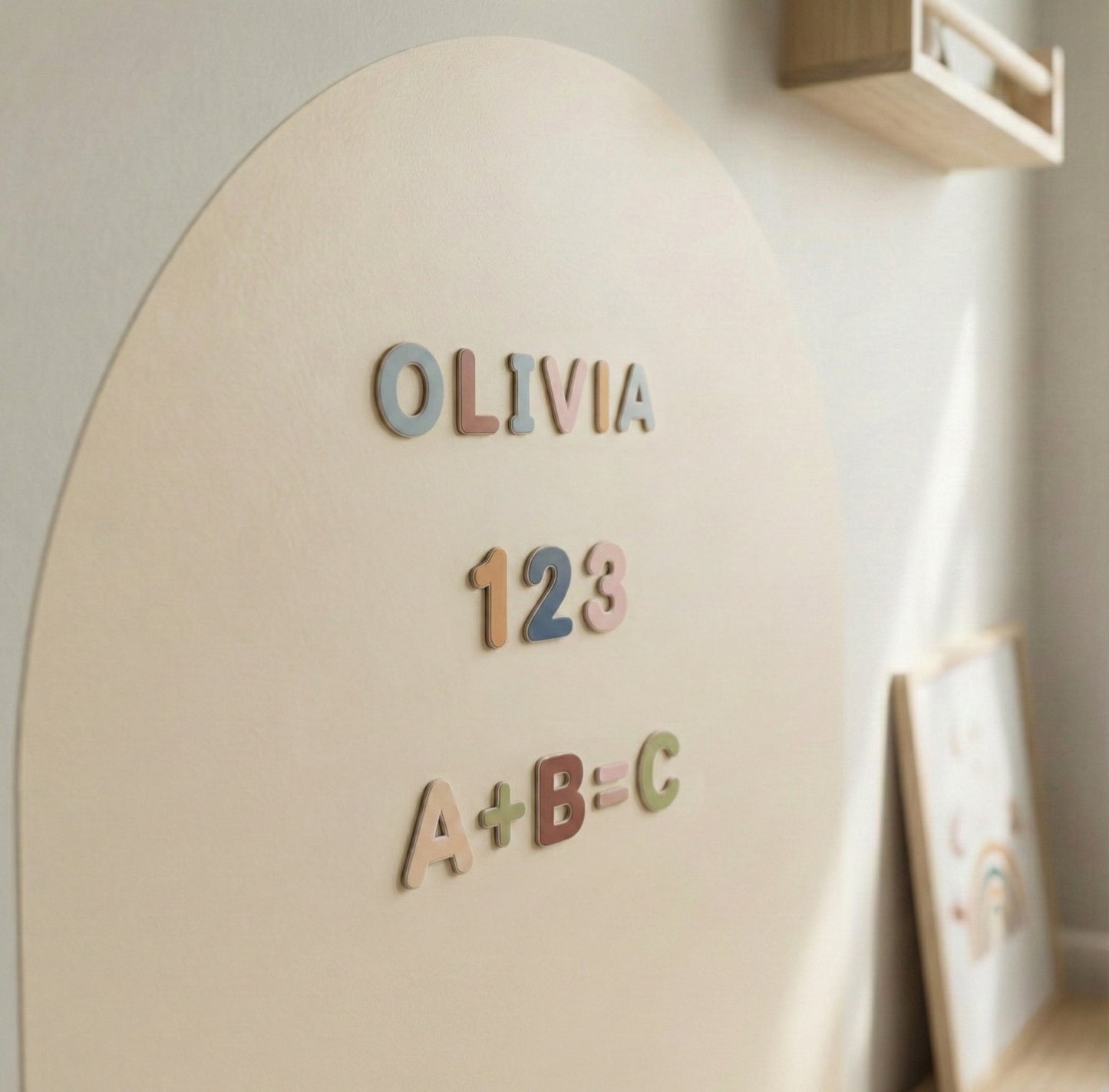 Personalized magnetic arch wall with wooden alphabet letters, numbers and Montessori learning magnets in a modern nursery